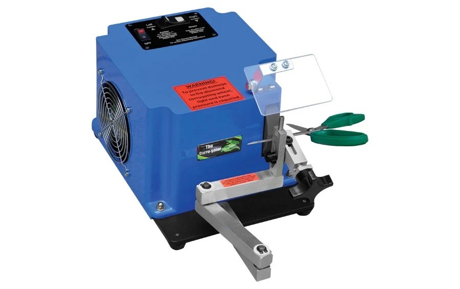 Blue scissor-sharpening machine with scissors held at the front